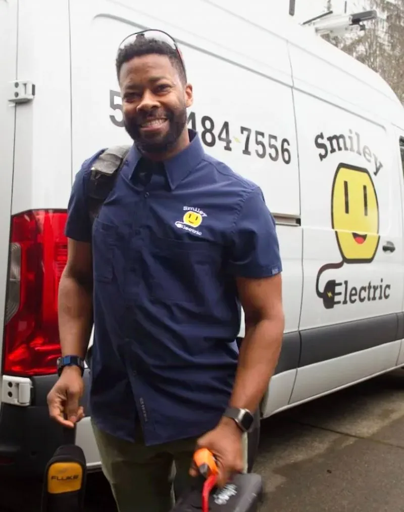 Joshua Smiley, owner and master electrician at Smiley Electric, in front of his branded van