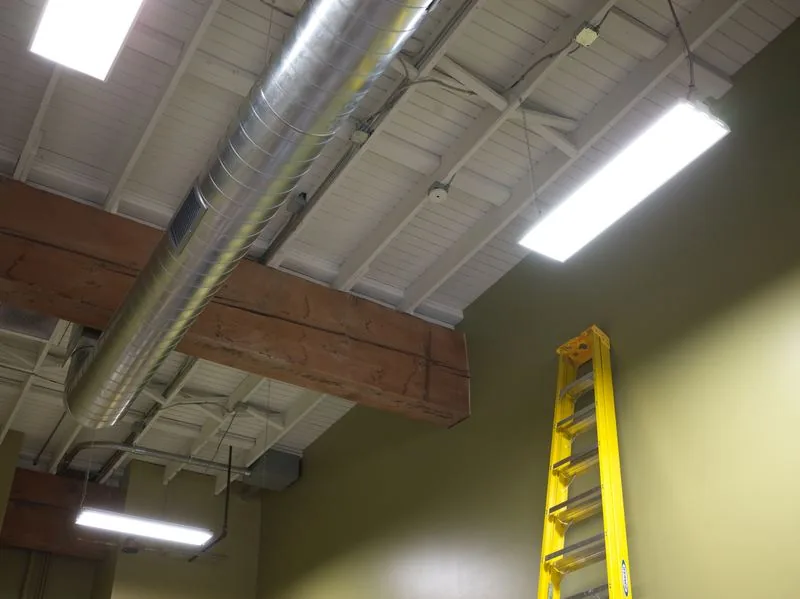 Commercial ceiling with new LED lighting and exposed ductwork