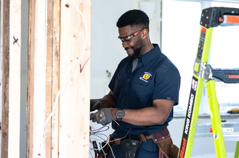 Electrician wiring an electrical panel at a job site